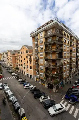 a parking lot with cars parked in front of a building at Veturia in Rome