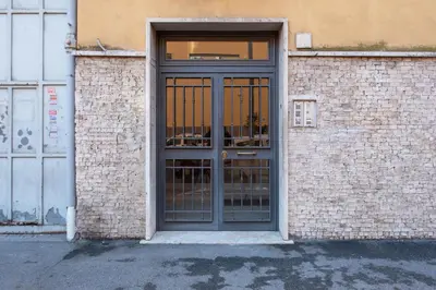 a door on a brick building with a window at Cielo di Roma con Terrazzo - Self Check-in 24h in Rome