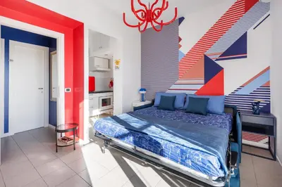 a bedroom with a bed with colorful walls at Cielo di Roma con Terrazzo - Self Check-in 24h in Rome