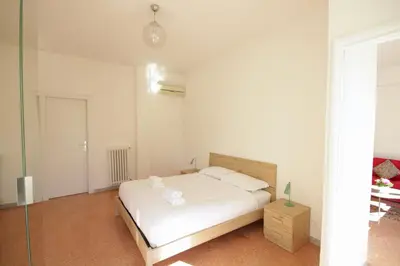 a white bedroom with a bed and a table at HC - Stadio Olimpico Huge Apartment NEW in Rome