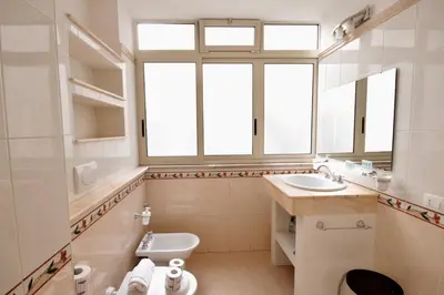 a bathroom with a sink and a toilet and a window at HC - Stadio Olimpico Huge Apartment NEW in Rome