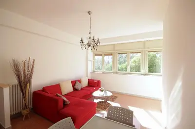 a living room with a red couch and a table at HC - Stadio Olimpico Huge Apartment NEW in Rome