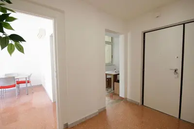 a white room with a table and a glass door at HC - Stadio Olimpico Huge Apartment NEW in Rome