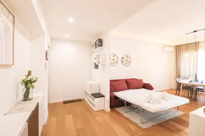 a living room with a couch and a table at Elegant & Chic 2 Suites Apartment - 5min to Station, AC, Wi-Fi in Rome