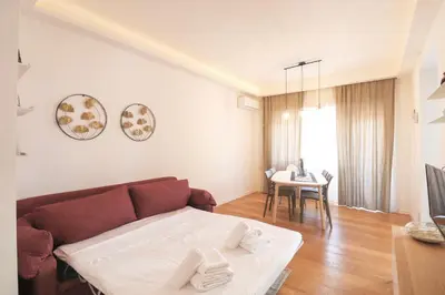a living room with a couch and a table at Elegant & Chic 2 Suites Apartment - 5min to Station, AC, Wi-Fi in Rome