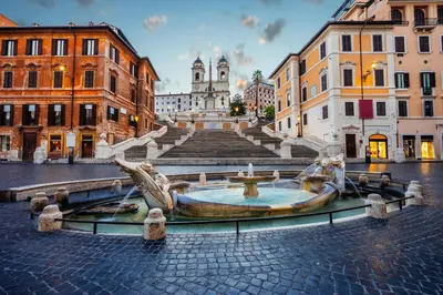 a fountain in the middle of a city at Elegant & Chic 2 Suites Apartment - 5min to Station, AC, Wi-Fi in Rome