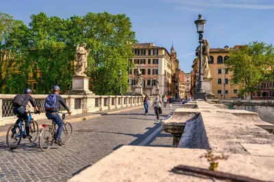 a group of people riding bikes on a bridge at Elegant & Chic 2 Suites Apartment - 5min to Station, AC, Wi-Fi in Rome
