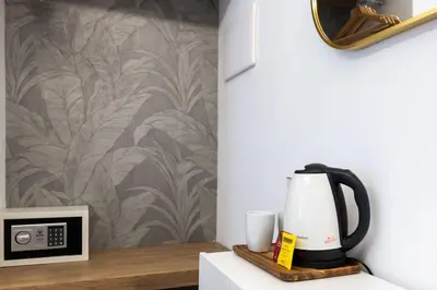 a coffee maker sitting on a counter next to a wall at G MARCONI Rooms & Suites in Rome