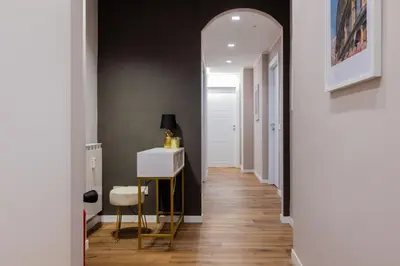 a hallway with a table and a chair in a room at G MARCONI Rooms & Suites in Rome