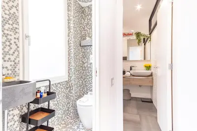 a bathroom with a toilet and a sink at Elegantis Penthouse in the Heart of Rome With Private Terrace and View in Rome