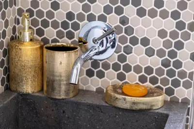 a sink with a faucet and two rolls of toilet paper at Elegantis Penthouse in the Heart of Rome With Private Terrace and View in Rome