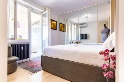 a bedroom with a large bed and a large mirror at Elegantis Penthouse in the Heart of Rome With Private Terrace and View in Rome