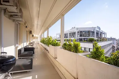a balcony with chairs and plants on a building at Elegantis Penthouse in the Heart of Rome With Private Terrace and View in Rome