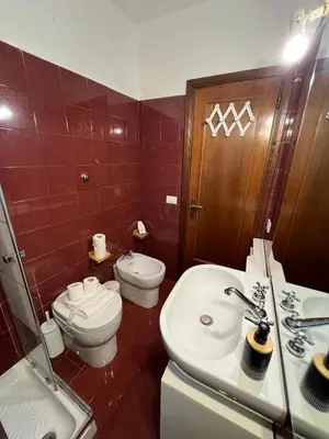 a bathroom with a toilet and a sink at La Dolce Vita - Rione Campo Marzio the Beating Heart of Rome in Rome