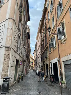 two people walking down a street in an alley at La Dolce Vita - Rione Campo Marzio the Beating Heart of Rome in Rome