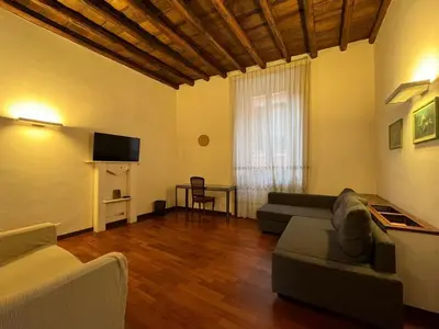 a living room with a couch and a tv at La Dolce Vita - Rione Campo Marzio the Beating Heart of Rome in Rome