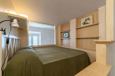 a couch sitting in a living room with shelves at GuestHost - Roma Tiburtina Apartment in Rome