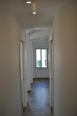 an empty hallway with two doors and a window at Giulio al MAXXI Apartment Flaminio in Rome