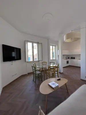a living room with a table and chairs and a tv at Giulio al MAXXI Apartment Flaminio in Rome