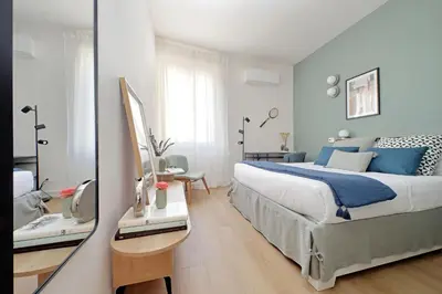 a bedroom with a large bed and a mirror at YCH-Eleganza e confort vicino metro re di Roma in Rome