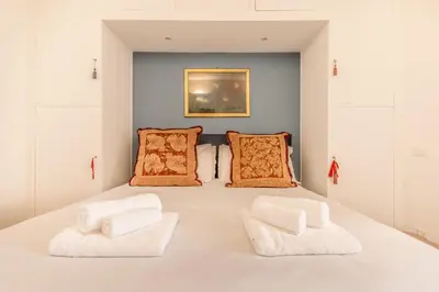 a bedroom with a bed with two white towels at Spagna Suite Dream by Ghor in Rome