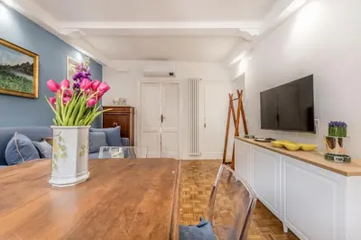 a dining room with a table with a vase of flowers at Spagna Suite Dream by Ghor in Rome