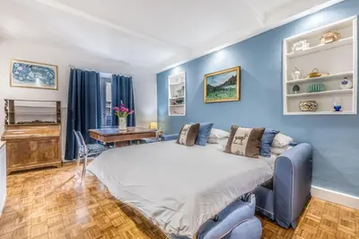 a bedroom with a large bed with blue walls at Spagna Suite Dream by Ghor in Rome