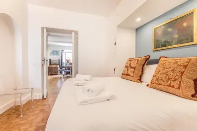 a bedroom with a large white bed with towels on it at Spagna Suite Dream by Ghor in Rome