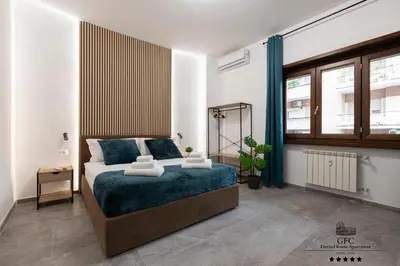 a bedroom with a bed and a large window at GFC Eternal Rome Apartment - 5min to Tiburtina Station MetroB, 2 Bathrooms, Terrace, A-C in Rome