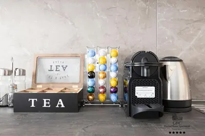 a table with a tea kettle and a box of balls at GFC Eternal Rome Apartment - 5min to Tiburtina Station MetroB, 2 Bathrooms, Terrace, A-C in Rome