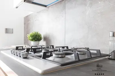 a kitchen with a stove top with a potted plant at GFC Eternal Rome Apartment - 5min to Tiburtina Station MetroB, 2 Bathrooms, Terrace, A-C in Rome