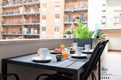 a table with plates of food on a balcony at GFC Eternal Rome Apartment - 5min to Tiburtina Station MetroB, 2 Bathrooms, Terrace, A-C in Rome