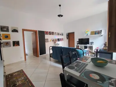 a living room with a table and a dining room at Casa del Vinile Roma in Rome