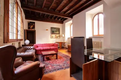 an empty alley with a bench and a palm tree at Roma Centro Storico - Palazzo Avila '500 in Rome