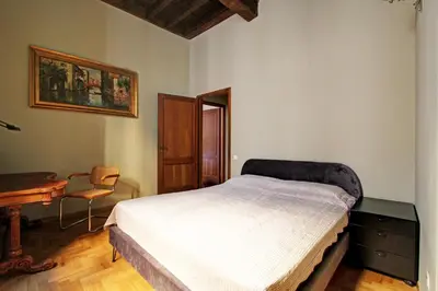 a living room with a red couch and a tv at Roma Centro Storico - Palazzo Avila '500 in Rome
