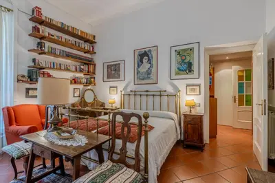 a bedroom with a bed and a table at Your cozy place at the Vatican in Rome