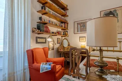 a living room with a chair and a lamp at Your cozy place at the Vatican in Rome