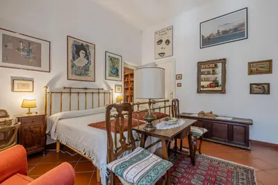 a bedroom with a bed and a table and a chair at Your cozy place at the Vatican in Rome
