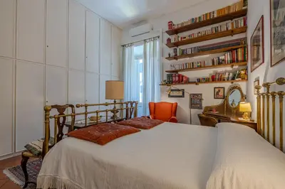 a bedroom with a bed and a chair and a desk at Your cozy place at the Vatican in Rome