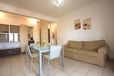 a living room with a table and a couch at Manuela Holiday House in Rome