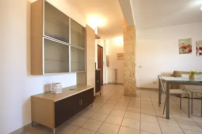 a kitchen and dining room with a table and a dining room at Manuela Holiday House in Rome