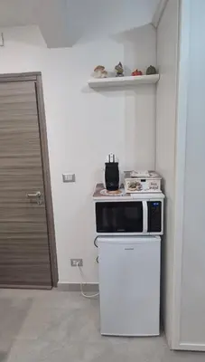 a kitchen with a microwave on top of a stove at Leone Bed & Dreams in Rome