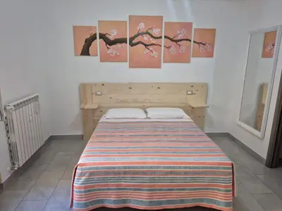 a bed in a room with paintings on the wall at Leone Bed & Dreams in Rome
