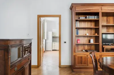 a dining room with a table and a television at Colosseum Monti large flat in Rome