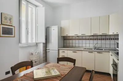 a kitchen with a table and a refrigerator at Colosseum Monti large flat in Rome