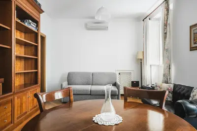 a living room with a table and a couch at Colosseum Monti large flat in Rome
