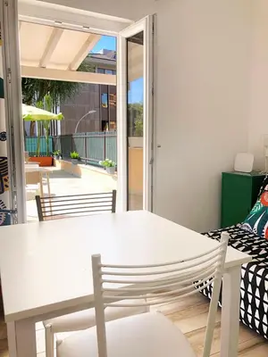 a white table and chairs in a living room at Wonderful little gem with a large private terrace! in Rome
