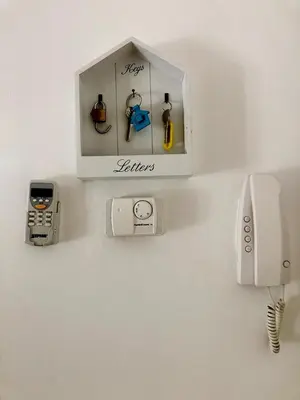 a wall with a clock and a phone on a wall at Wonderful little gem with a large private terrace! in Rome