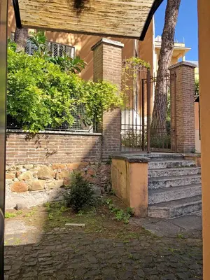 a brick house with stairs and a fence at Wonderful little gem with a large private terrace! in Rome