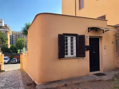 a building with a black door and a window at Wonderful little gem with a large private terrace! in Rome